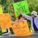 Supporters wave to cars and hold signs in support of Camp Take Notice as a means to promote awareness and raise funds for the camp during a rally along Wagner Road on Thursday.  Melanie Maxwell I AnnArbor.com